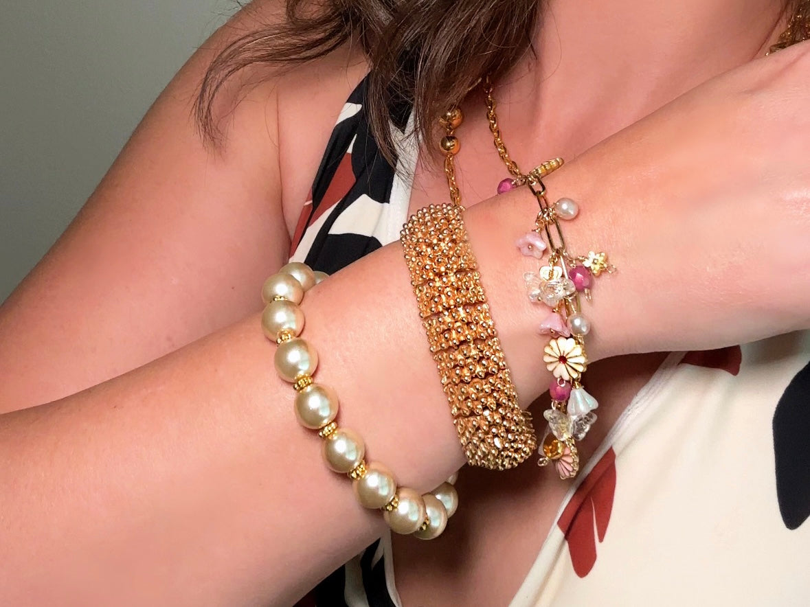 This classic pearl bracelet is handmade with gorgeous champagne pearls, gold filigree accents, and 18K hardware. The gold accents paired with the creamy champagne pearls are a classic and timeless design. This bracelet looks fantastic worn alone- or stack it with others to make a statement. This bracelet is made to order. Please select your desired base length at check out- a 1.5" extension will be added to easily customize the fit. Lobster clasp closure. A beautiful pearl bracelet- matching earrings are