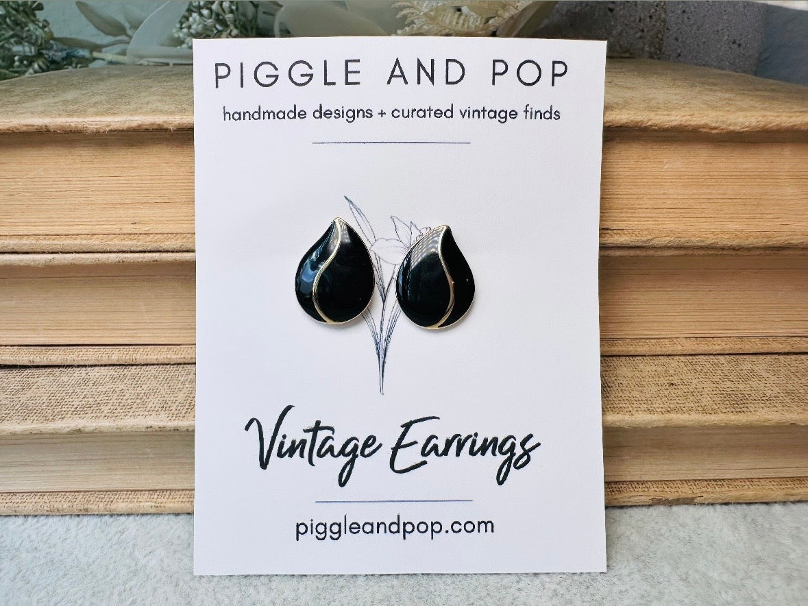 These black vintage teardrop earrings are an awesome pair of classic everyday earrings. Beautiful glossy black enamel with a gold curved stripe up the middle, these dainty teardrops are destined to become a favorite pair. These vintage post earrings are simple and elegant. Pierced style- in excellent vintage condition 1980s, please see pics.