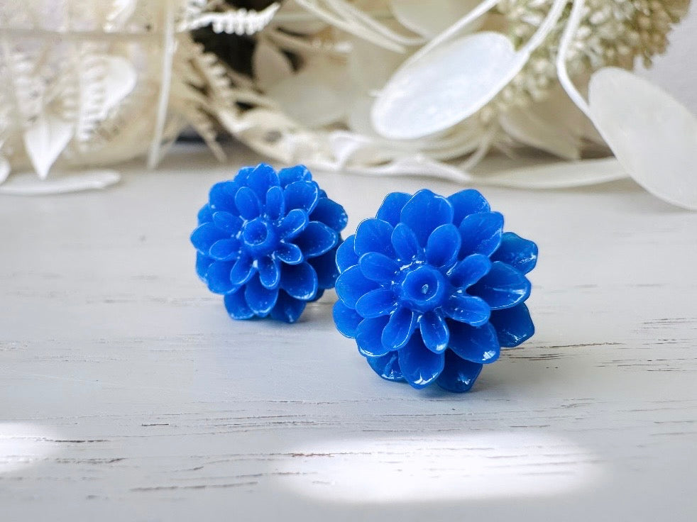 These bright cobalt blue dahlia flower stud earrings are the perfect accent to brighten up your outfit. These handmade glossy resin flower earrings feature hypoallergenic surgical steel posts with butterfly backs- ideal for sensitive ears. These whimsical earrings will arrive beautifully packaged and ready for gift giving (for yourself or another!) at no extra charge.