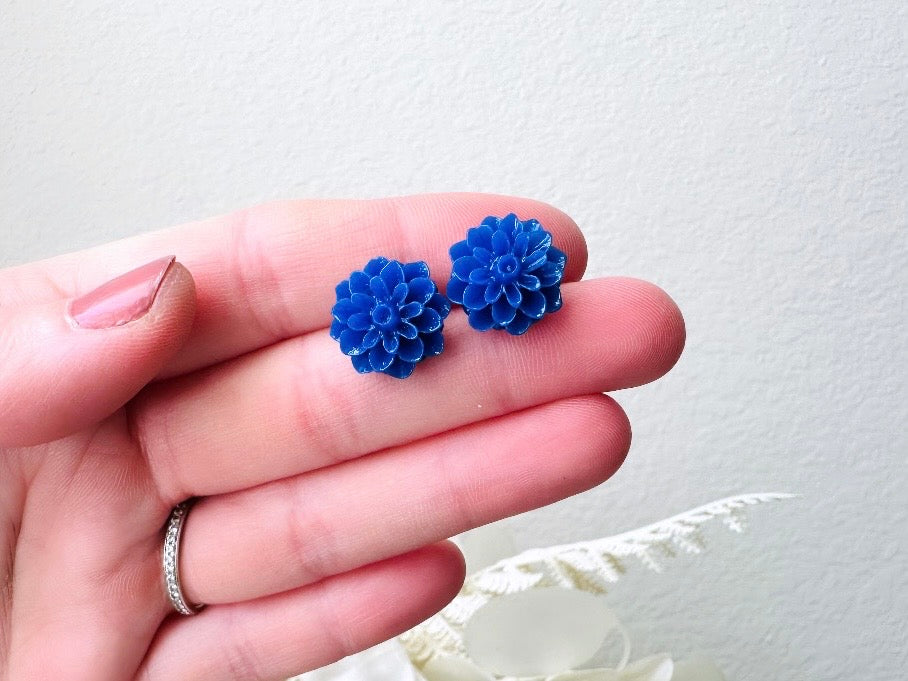 These bright cobalt blue dahlia flower stud earrings are the perfect accent to brighten up your outfit. These handmade glossy resin flower earrings feature hypoallergenic surgical steel posts with butterfly backs- ideal for sensitive ears. These whimsical earrings will arrive beautifully packaged and ready for gift giving (for yourself or another!) at no extra charge.
