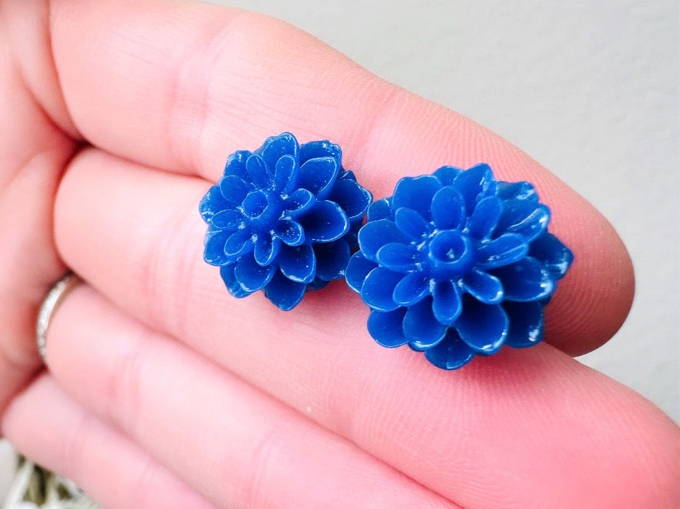 These bright cobalt blue dahlia flower stud earrings are the perfect accent to brighten up your outfit. These handmade glossy resin flower earrings feature hypoallergenic surgical steel posts with butterfly backs- ideal for sensitive ears. These whimsical earrings will arrive beautifully packaged and ready for gift giving (for yourself or another!) at no extra charge.