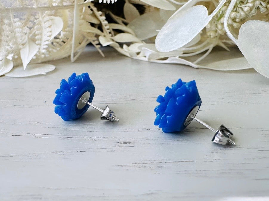 These bright cobalt blue dahlia flower stud earrings are the perfect accent to brighten up your outfit. These handmade glossy resin flower earrings feature hypoallergenic surgical steel posts with butterfly backs- ideal for sensitive ears. These whimsical earrings will arrive beautifully packaged and ready for gift giving (for yourself or another!) at no extra charge.