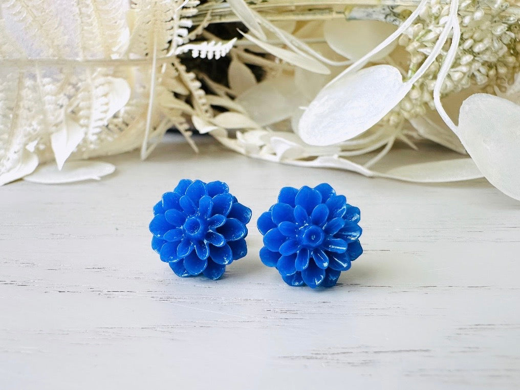 These bright cobalt blue dahlia flower stud earrings are the perfect accent to brighten up your outfit. These handmade glossy resin flower earrings feature hypoallergenic surgical steel posts with butterfly backs- ideal for sensitive ears. These whimsical earrings will arrive beautifully packaged and ready for gift giving (for yourself or another!) at no extra charge.