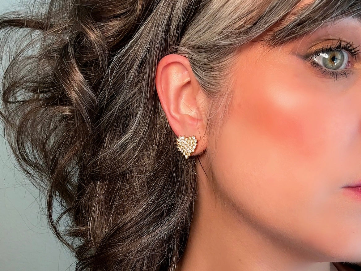 These crystal heart earrings are a stunning pair of vintage Roman Designer pave diamond rhinestone earrings. These pierced post heart stud earrings have an understated elegance, perfect for cocktail hour, or a bridal look. These are post/stud style for pierced ears, from the 1990s. Modelled for size reference.