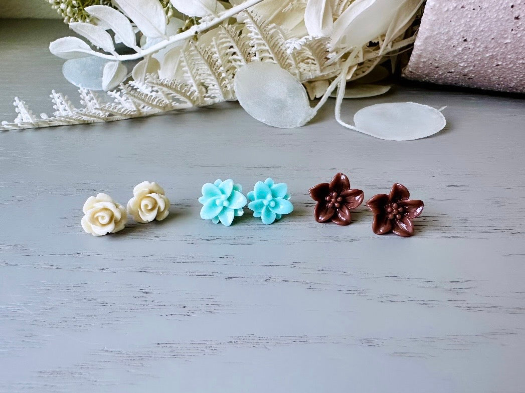 This listing is for three lovely pairs of handmade resin flower earrings. Cream roses, mint lotuses and chocolate brown lilies are paired up in a chic feminine set. These semi- glossy floral earrings are mounted on hypoallergenic surgical steel posts with butterfly backs. Dressed up or down, they are perfect for any occasion!