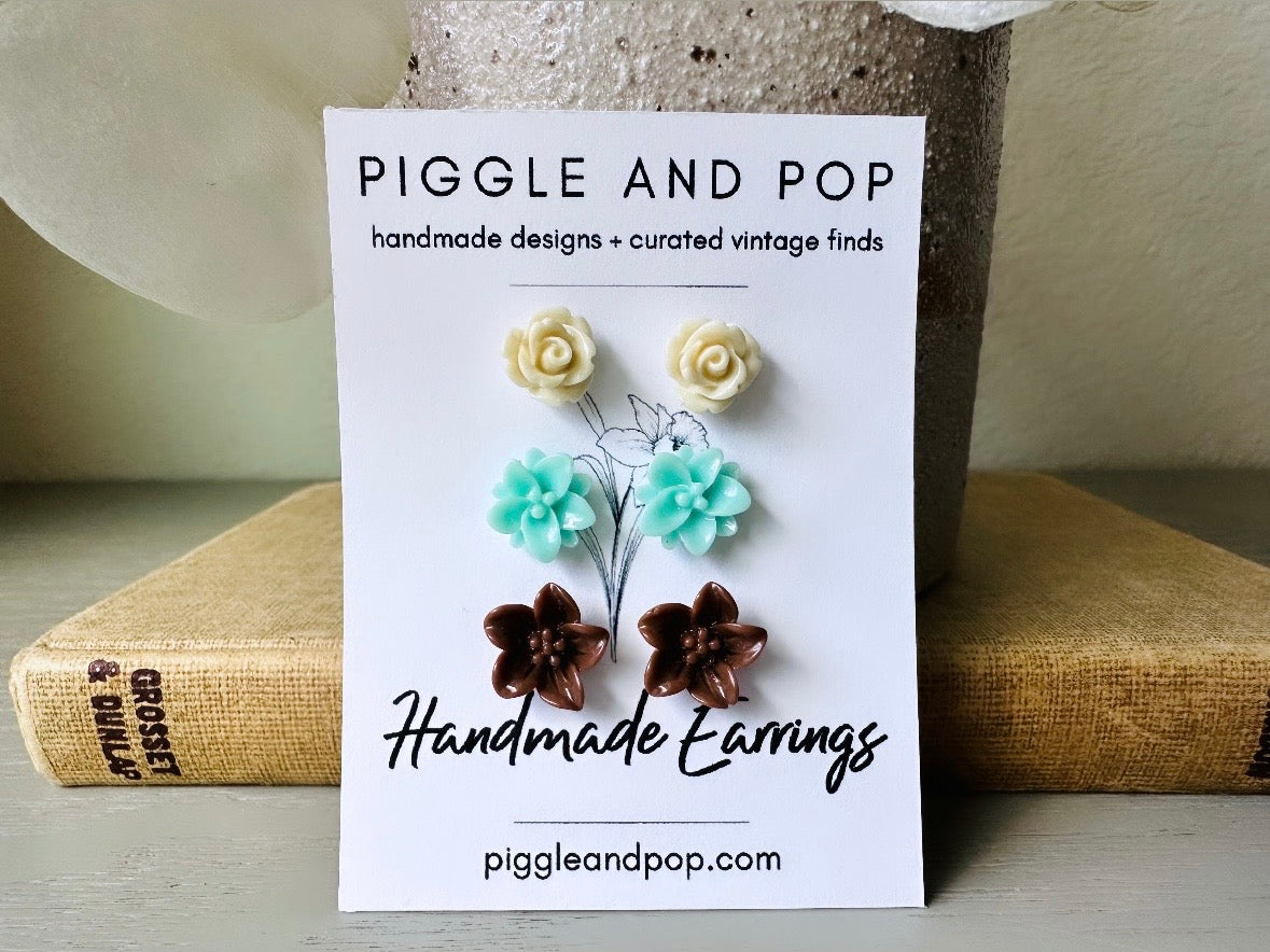 This listing is for three lovely pairs of handmade resin flower earrings. Cream roses, mint lotuses and chocolate brown lilies are paired up in a chic feminine set. These semi- glossy floral earrings are mounted on hypoallergenic surgical steel posts with butterfly backs. Dressed up or down, they are perfect for any occasion!