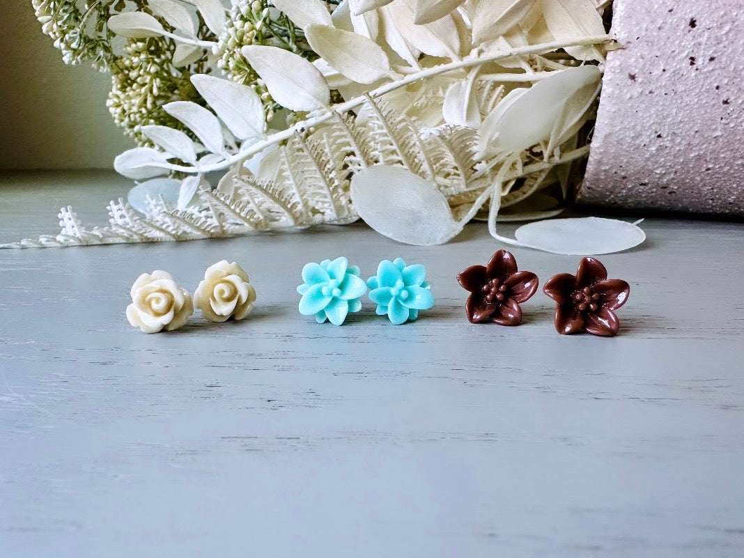 This listing is for three lovely pairs of handmade resin flower earrings. Cream roses, mint lotuses and chocolate brown lilies are paired up in a chic feminine set. These semi- glossy floral earrings are mounted on hypoallergenic surgical steel posts with butterfly backs. Dressed up or down, they are perfect for any occasion!