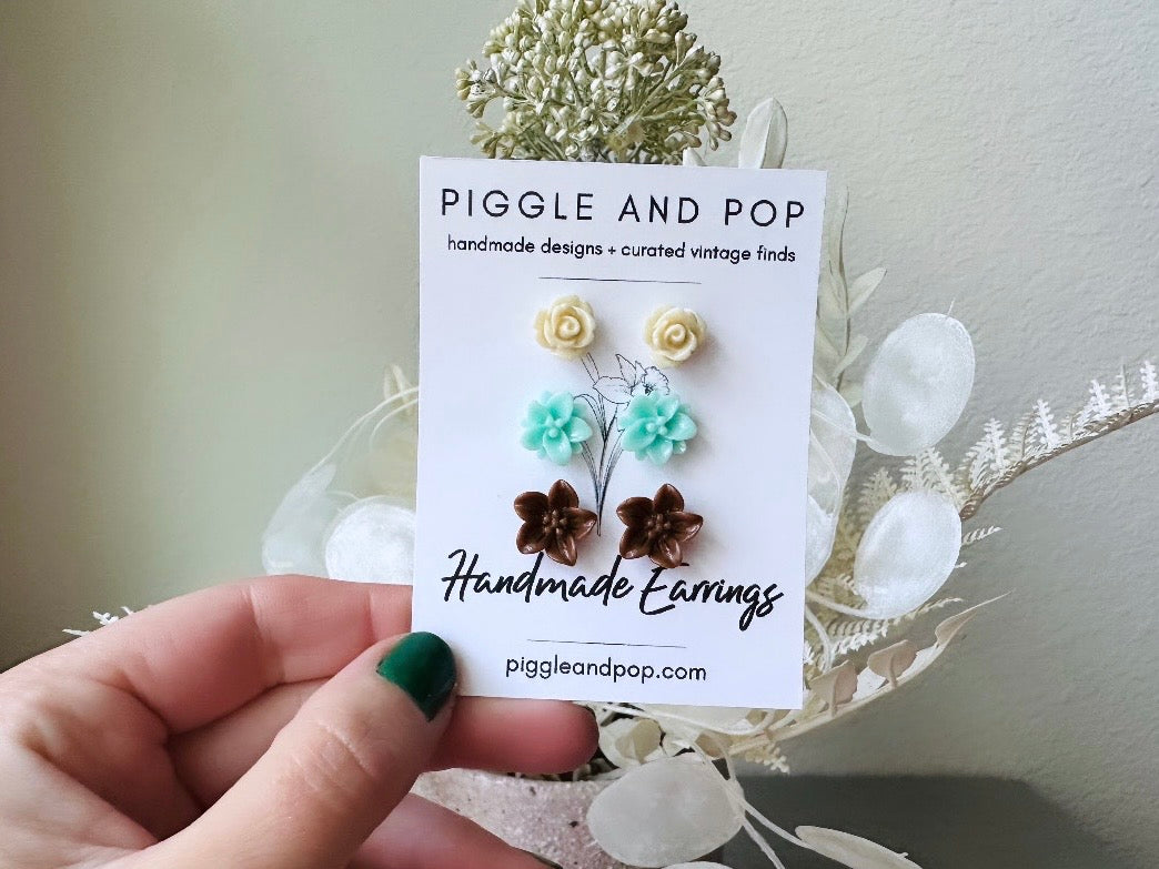 This listing is for three lovely pairs of handmade resin flower earrings. Cream roses, mint lotuses and chocolate brown lilies are paired up in a chic feminine set. These semi- glossy floral earrings are mounted on hypoallergenic surgical steel posts with butterfly backs. Dressed up or down, they are perfect for any occasion!