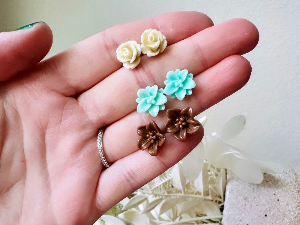 This listing is for three lovely pairs of handmade resin flower earrings. Cream roses, mint lotuses and chocolate brown lilies are paired up in a chic feminine set. These semi- glossy floral earrings are mounted on hypoallergenic surgical steel posts with butterfly backs. Dressed up or down, they are perfect for any occasion!