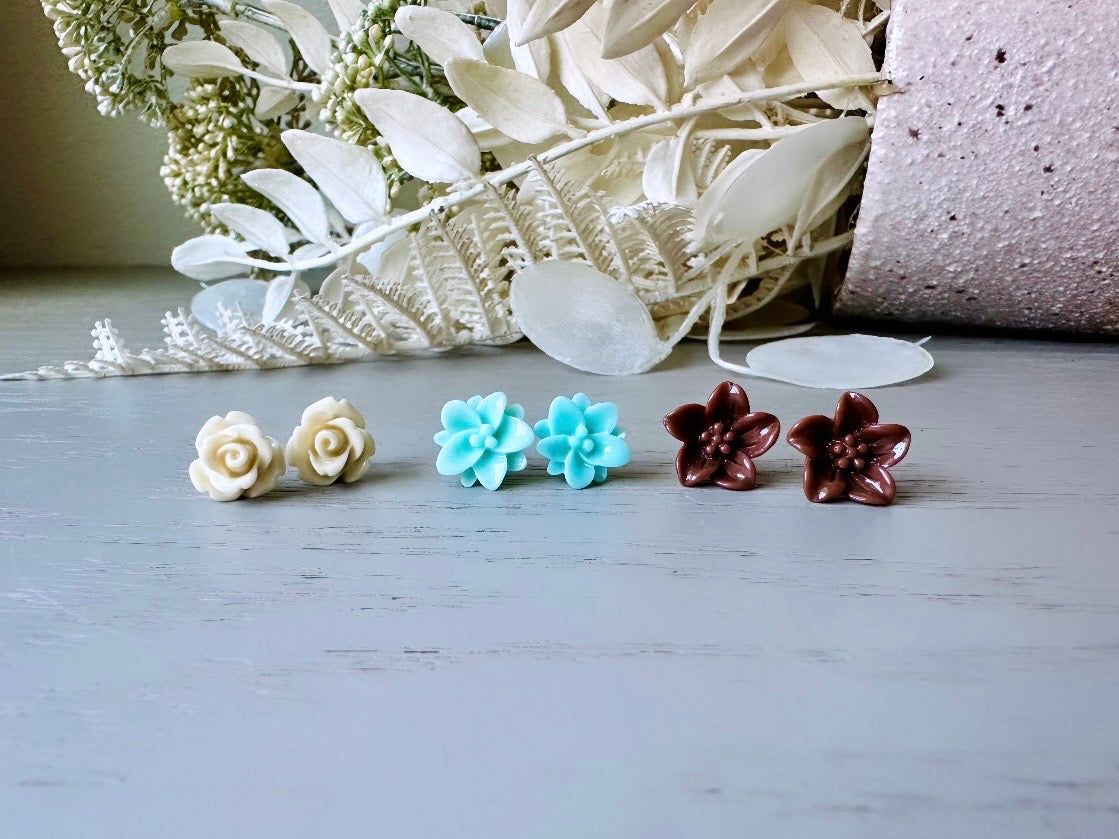 This listing is for three lovely pairs of handmade resin flower earrings. Cream roses, mint lotuses and chocolate brown lilies are paired up in a chic feminine set. These semi- glossy floral earrings are mounted on hypoallergenic surgical steel posts with butterfly backs. Dressed up or down, they are perfect for any occasion!