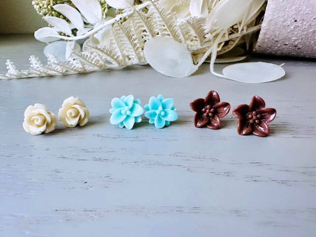 This listing is for three lovely pairs of handmade resin flower earrings. Cream roses, mint lotuses and chocolate brown lilies are paired up in a chic feminine set. These semi- glossy floral earrings are mounted on hypoallergenic surgical steel posts with butterfly backs. Dressed up or down, they are perfect for any occasion!