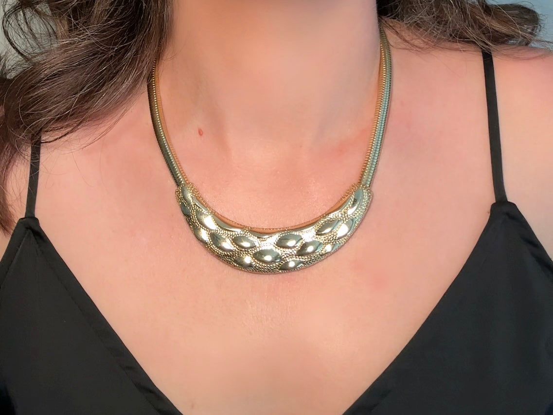 This gold omega necklace is a Park Lane signed designer vintage choker necklace from the 1980s. Featuring wide band gold snake chain with a textured raised geometric crescent bar, this gold collar necklace is bold and beautiful. In excellent vintage condition, signed Park Lane on back.