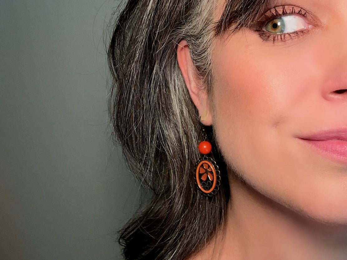 These orange flower enamel and bronze 70s vintage dangle earrings are fabulously funky. A lacey cameo featuring an orange enamel flower linked with a glossy orange bead. A very fun pair, the color is amazing- in great vintage condition, please view all pics.