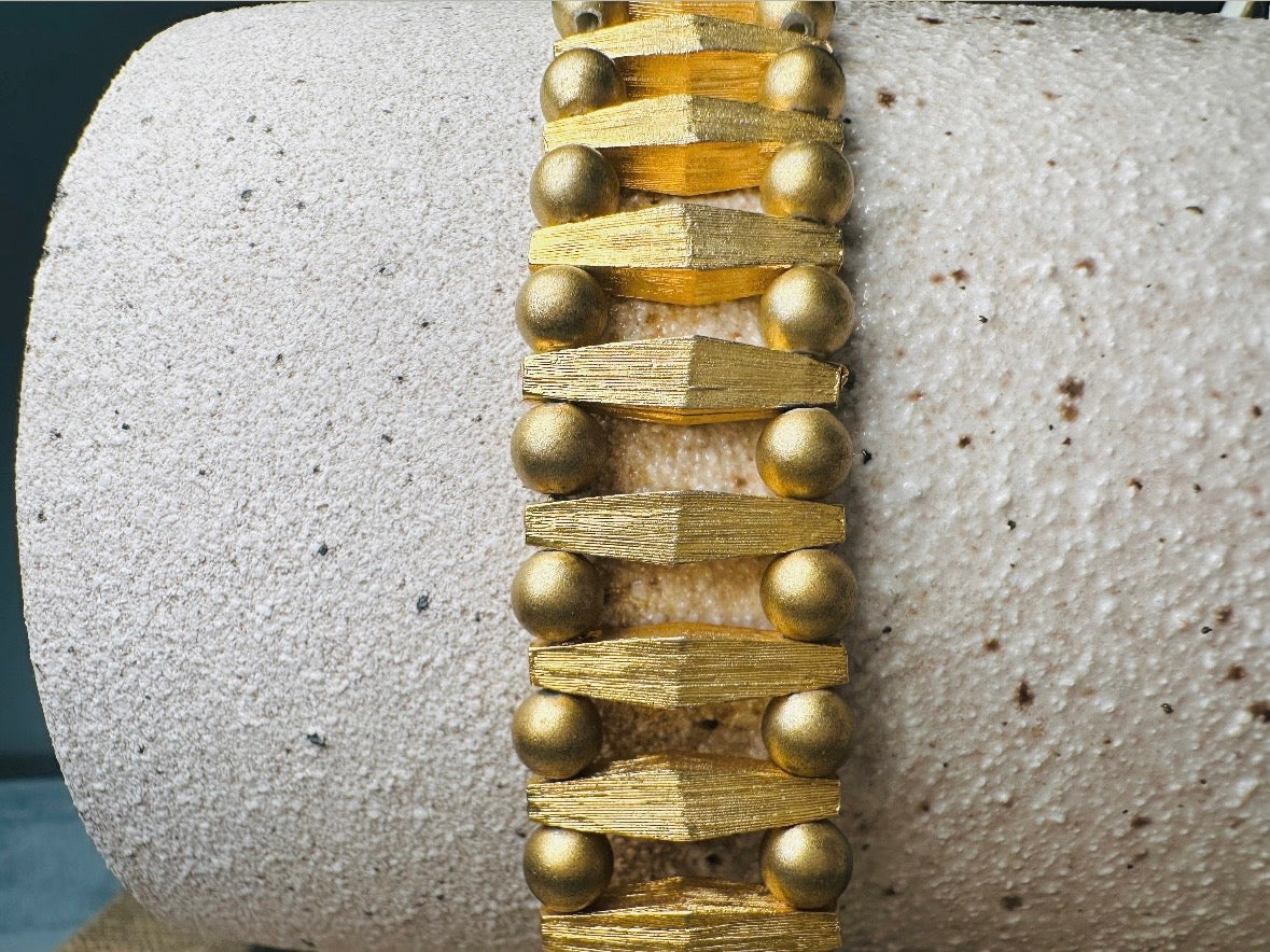 This bold 1970s vintage gold bracelet is so unique- featuring brushed gold bars and smooth polished gold beads. This chunky gold bracelet is timeless and would pair well with a variety of other pieces. An unsigned one of a kind bracelet and perfect jewelry gift for the vintage lover. Structural geometric pieces are currently trending. In great vintage condition, some very minor gold wear on hinge clip- please view all pics.