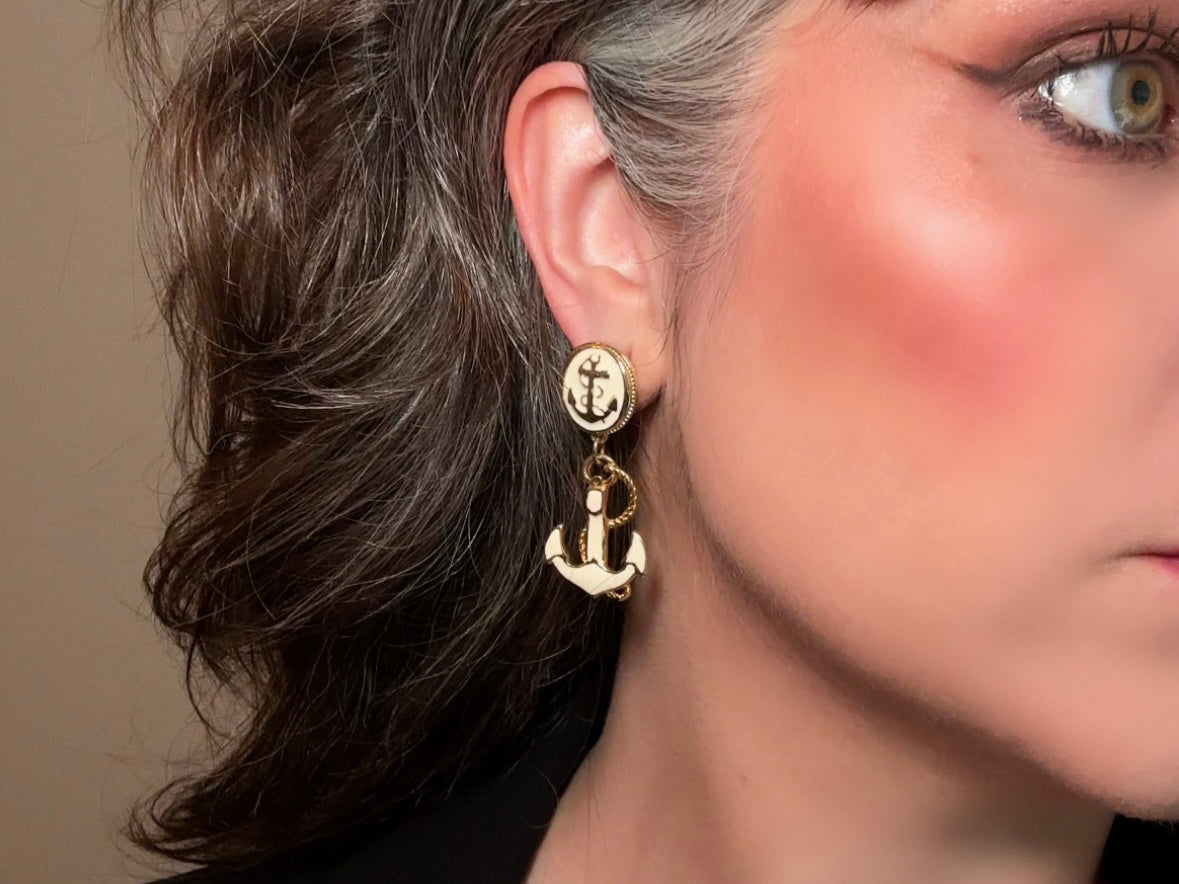 These cream and gold vintage anchor earrings are a gorgeous pair of nautical statement earrings by Park Lane. Featuring dreamy cream enamel and gold anchor and rope accent details, these pierced style dangle earrings are a classic and perfect for summer!