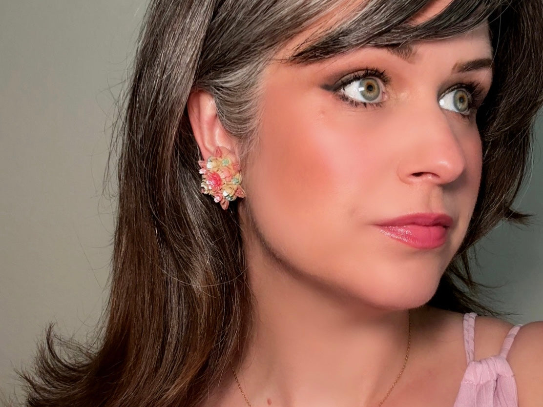 Shown on model. These vintage 1950s Japanese floral celluloid earrings are so colorful. Carved celluloid bursting with sakura blossoms and flowers, these earrings are on the larger side and are painted with a beautiful pearlized pink, blue and light cream. The star-shaped base and raised beaded edges are also characteristic of vintage Japanese celluloid jewelry. They are 1.5" in size.