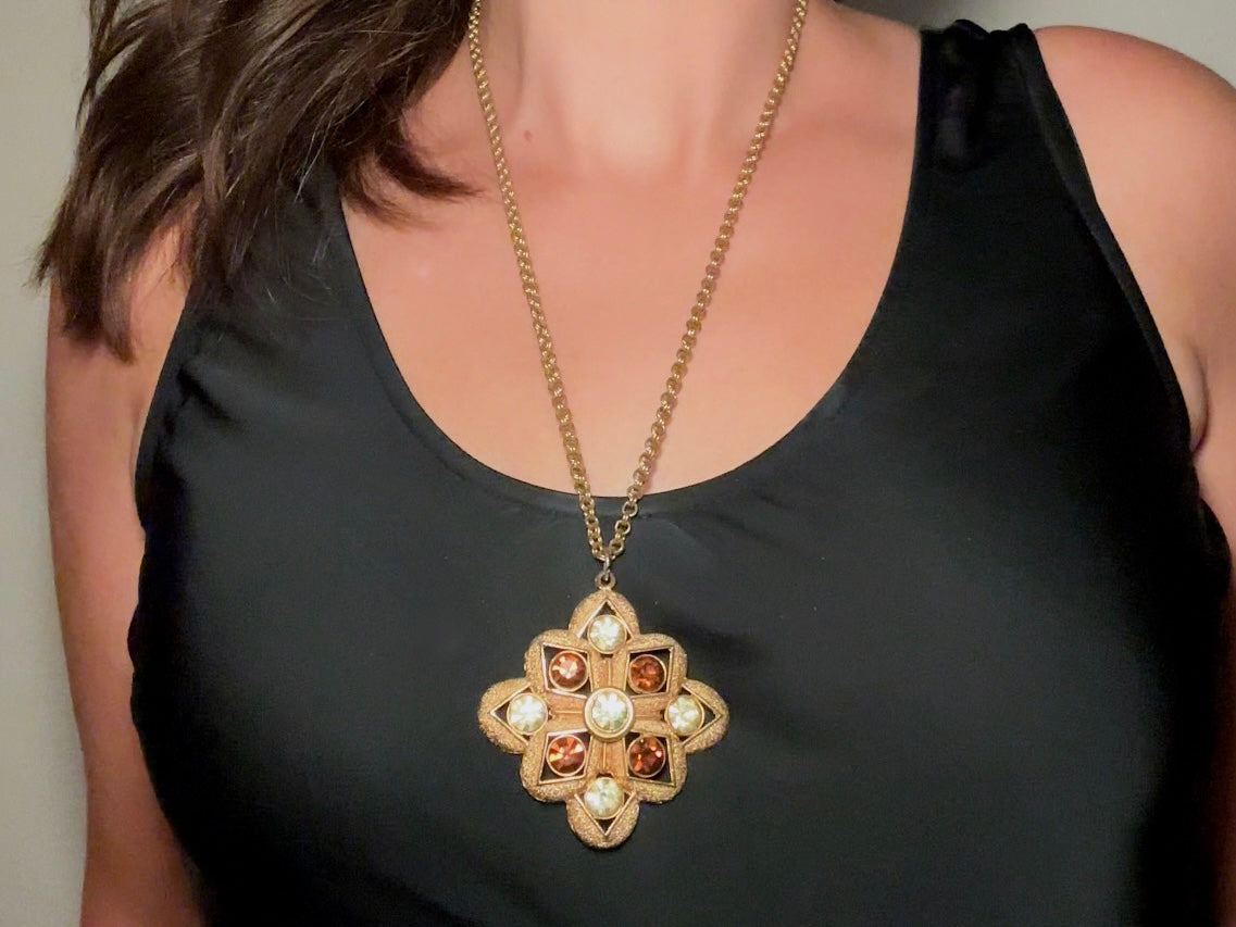 This 1970s vintage gold maltese cross pendant necklace is absolutely stunning! Featuring shimmering crystals in topaz and citrine set in a textured gold Etruscan pendant. This large bold vintage pendant is suspended from its original double link gold rolo chain, that fastens with a spring ring clasp. Signed SC from 1975.
