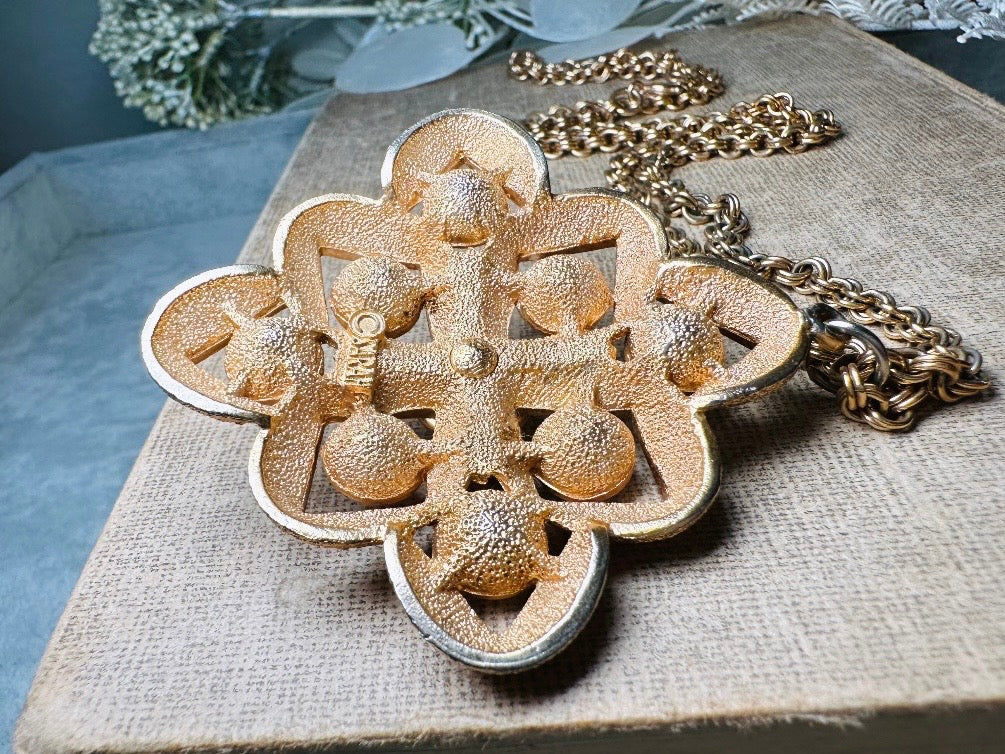 This 1970s vintage gold maltese cross pendant necklace is absolutely stunning! Featuring shimmering crystals in topaz and citrine set in a textured gold Etruscan pendant. This large bold vintage pendant is suspended from its original double link gold rolo chain, that fastens with a spring ring clasp. Signed SC from 1975.