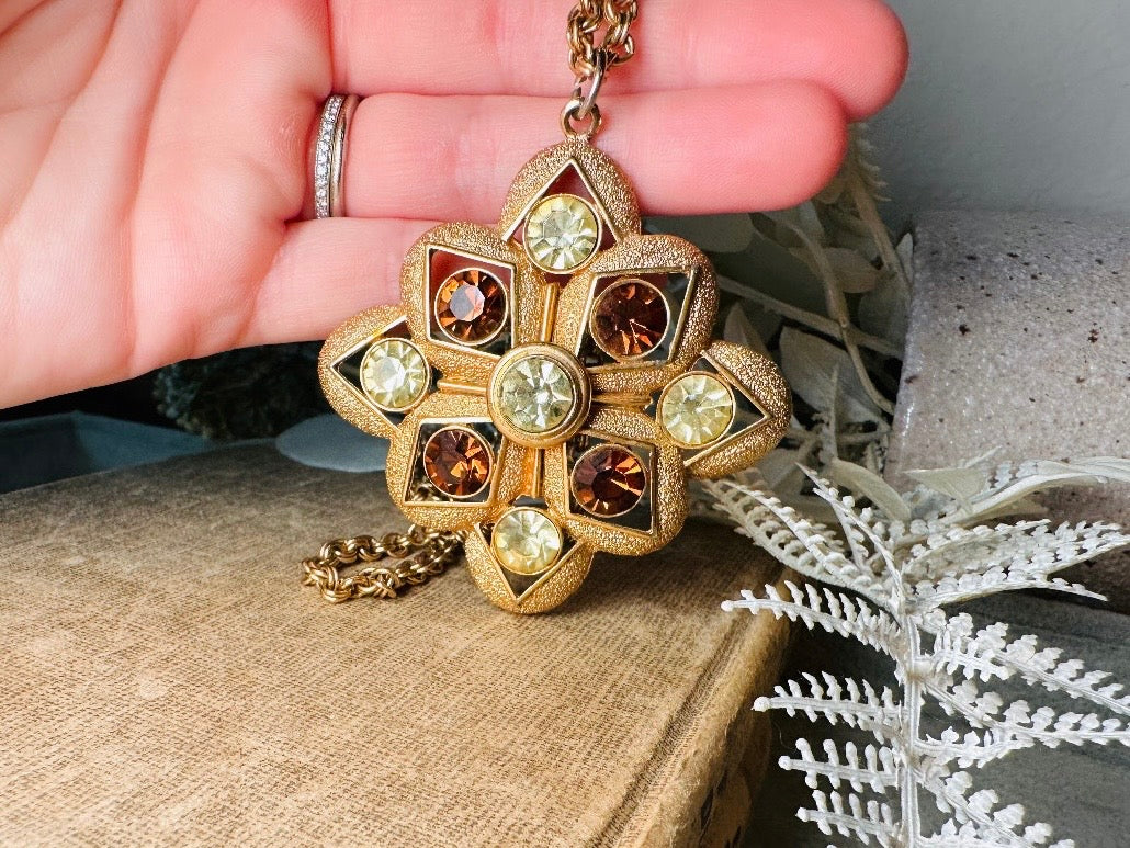 This 1970s vintage gold maltese cross pendant necklace is absolutely stunning! Featuring shimmering crystals in topaz and citrine set in a textured gold Etruscan pendant. This large bold vintage pendant is suspended from its original double link gold rolo chain, that fastens with a spring ring clasp. Signed SC from 1975.