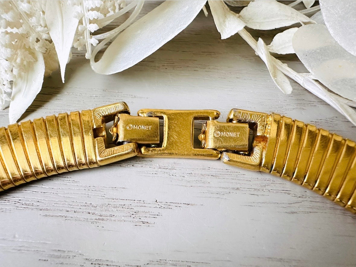 This vintage omega necklace is a stunning black and gold Monet designer vintage necklace. Featuring wide band snake chain and geometric segments of black enamel. This 1980s vintage rhinestone collar necklace has a fold over clasp and extender link. Excellent condition. This vintage designer necklace is high quality, weighty and well made.