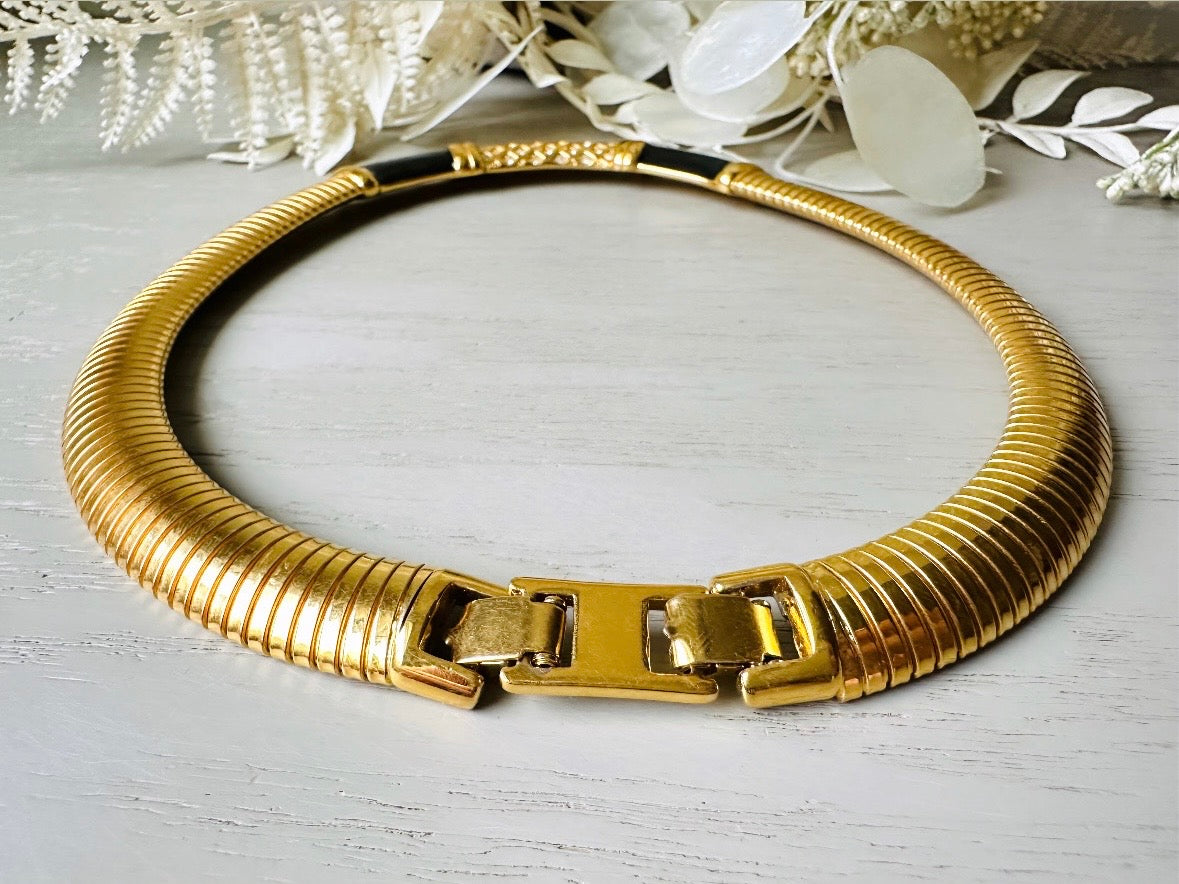 This vintage omega necklace is a stunning black and gold Monet designer vintage necklace. Featuring wide band snake chain and geometric segments of black enamel. This 1980s vintage rhinestone collar necklace has a fold over clasp and extender link. Excellent condition. This vintage designer necklace is high quality, weighty and well made.
