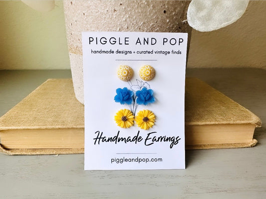 This floral stud earring set is full of my favorite flowers! A unique pair of domed yellow earrings with a white daisy cluster print, vibrant capri blue lotuses that are matte and slightly frosty, and a sunny pair of yellow gerber daisies. &nbsp;These handmade resin flower earrings feature hypoallergenic surgical steel posts with butterfly backs making them great for sensitive ears + comfortable all day wear.

Dimensions: &nbsp;10mm, 12mm, 13mm