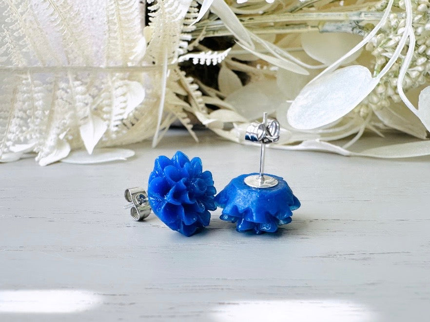 These bright cobalt blue dahlia flower stud earrings are the perfect accent to brighten up your outfit. These handmade glossy resin flower earrings feature hypoallergenic surgical steel posts with butterfly backs- ideal for sensitive ears. These whimsical earrings will arrive beautifully packaged and ready for gift giving (for yourself or another!) at no extra charge.