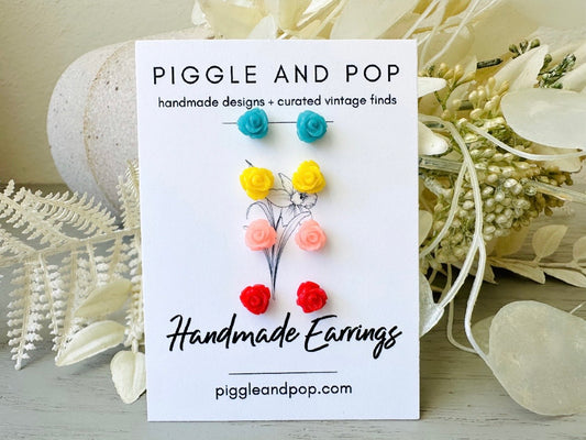 This handmade rose stud earring gift set features small resin rose earrings in a bright summery color pallet. Dreamy teal blue, sunny yellow, juicy melon and bright red; a pair suitable for every summer outfit. These dainty floral earrings are handmade with hypoallergenic surgical steel posts and butterfly backs- perfect for everyday wear and sensitive ears. Earrings will arrive beautifully packaged and ready for gift giving.

Dimensions: 7.5mm in diameter
