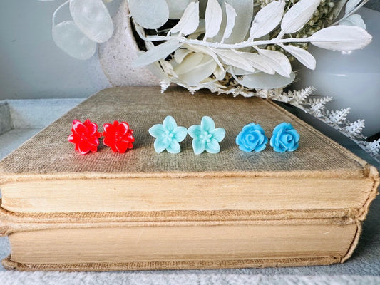 This handmade resin flower stud earring set features 3 pairs of cute floral post earrings in vibrant colors. This earring gift set features glossy bright red lotuses, mint stargazer lilies and sky blue roses. These flower stud earrings are made with hypoallergenic surgical steel posts and butterfly backs. These earrings will arrive beautifully packaged and ready for gift giving (for yourself or another!) at no extra charge. Custom color requests are warmly welcomed- please message me to create your own!