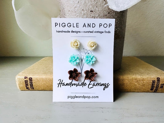 This listing is for three lovely pairs of handmade resin flower earrings. Cream roses, mint lotuses and chocolate brown lilies are paired up in a chic feminine set. These semi- glossy floral earrings are mounted on hypoallergenic surgical steel posts with butterfly backs. Dressed up or down, they are perfect for any occasion!