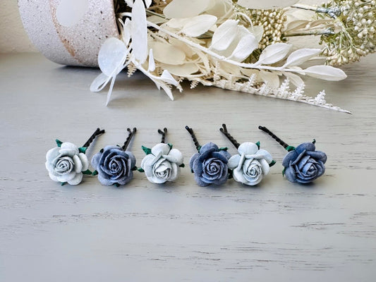 Six handmade rose hair pins with small grey paper flowers. The flowers are in shades of gray; three light silvery grey and three dark charcoal grey. The hair pins are dark bronze.