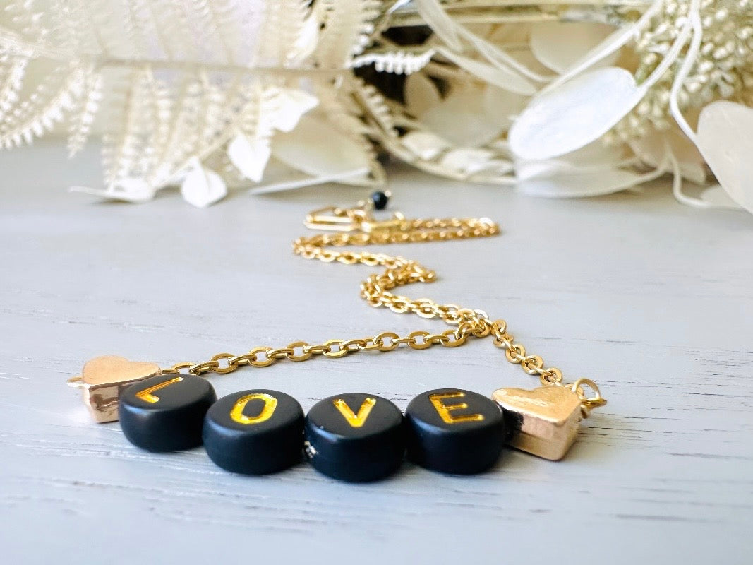 Handmade Love Beaded Necklace, 18k Chain Black and Gold Heart  close up angle