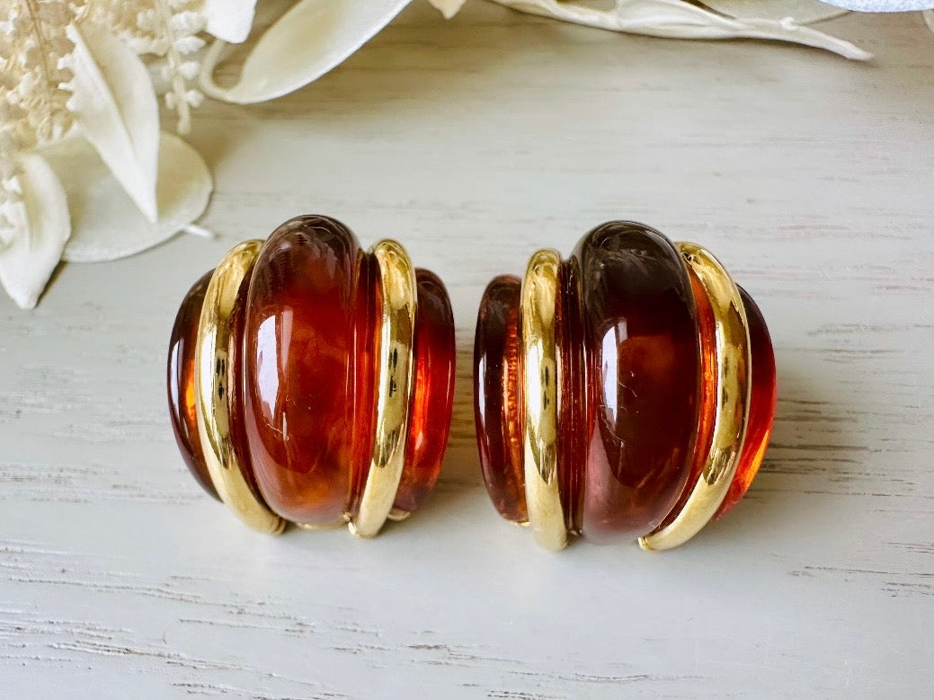 close up of amber and gold vintage clip ons