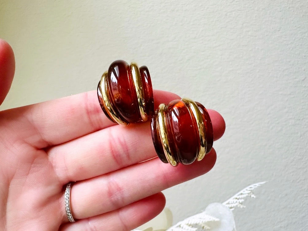 Amber KJL vintage earrings held in hand