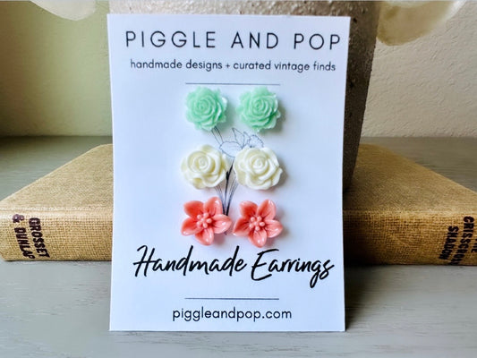 This flower earring set is full of the prettiest colors! Minty green bloomed roses, cream peonies and deep dusty rose lilies- a wonderful set of everyday earrings. These handmade resin flower earrings have hypoallergenic surgical steel posts with butterfly backs making them great for sensitive ears + comfortable all day wear.