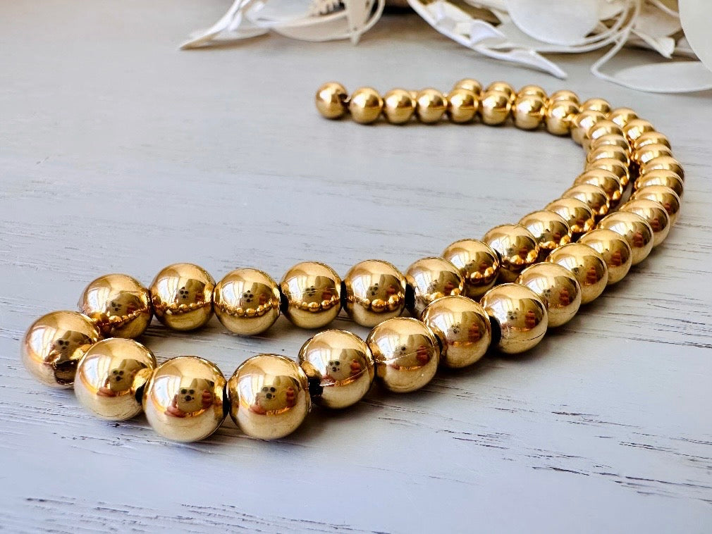 close up side shot of Napier Shiny Gold Ball Chain Choker Vintage Designer Necklace
