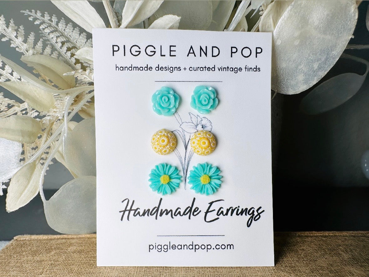 This mint and yellow flower earring set features a summery color combination and unique floral shapes. Cool mint roses, vintage yellow daisy studs with a white floral inlay and turquoise + yellow gerber daisies are paired up in a beautifully colorful set. These handmade resin earrings feature hypoallergenic surgical steel posts (ideal for sensitive ears!).  