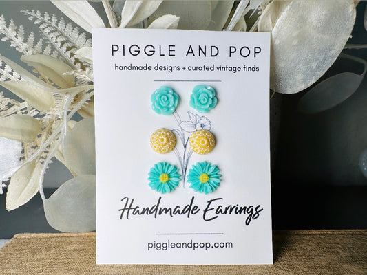 This mint and yellow flower earring set features a summery color combination and unique floral shapes. Cool mint roses, vintage yellow daisy studs with a white floral inlay and turquoise + yellow gerber daisies are paired up in a beautifully colorful set. These handmade resin earrings feature hypoallergenic surgical steel posts (ideal for sensitive ears!).  