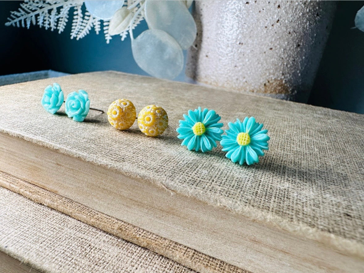 This mint and yellow flower earring set features a summery color combination and unique floral shapes. Cool mint roses, vintage yellow daisy studs with a white floral inlay and turquoise + yellow gerber daisies are paired up in a beautifully colorful set. These handmade resin earrings feature hypoallergenic surgical steel posts (ideal for sensitive ears!). 