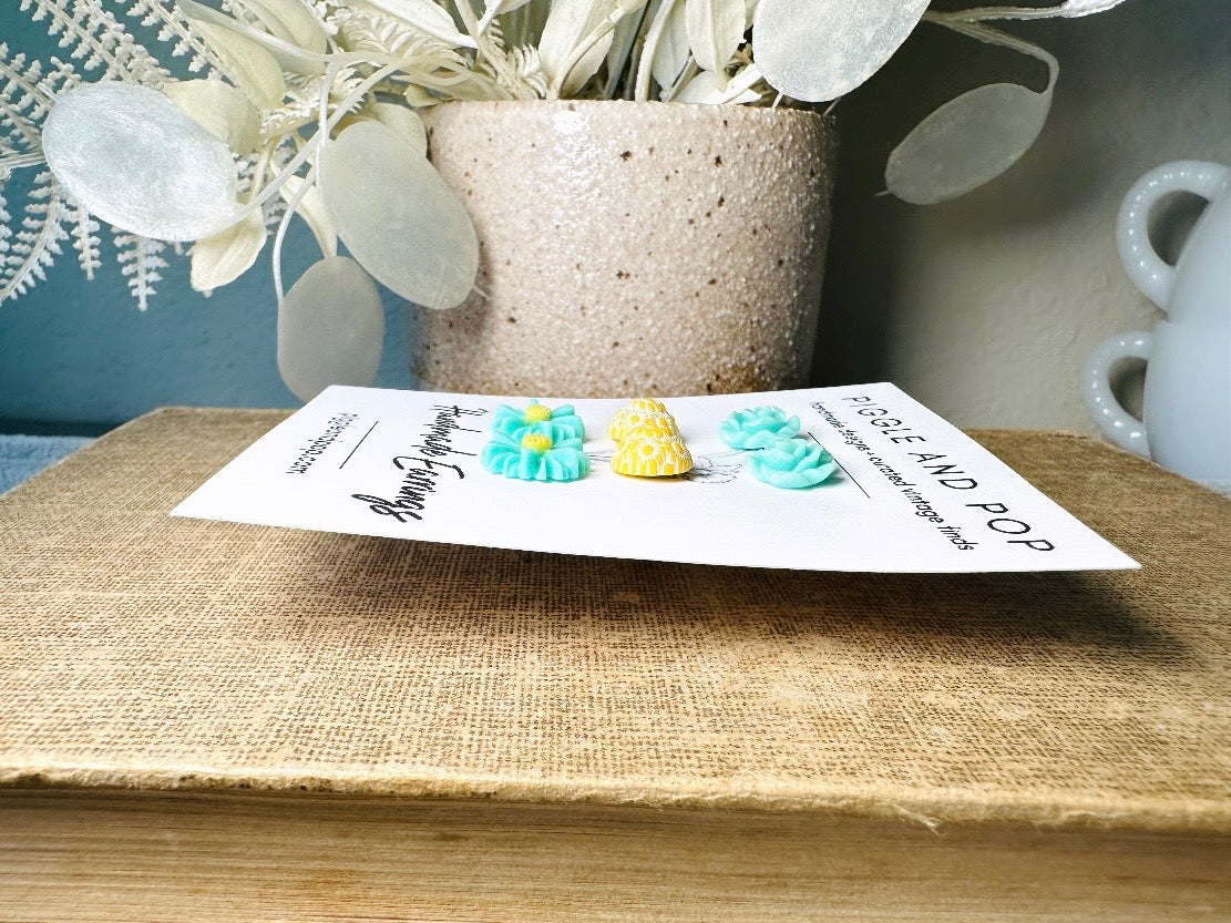 This mint and yellow flower earring set features a summery color combination and unique floral shapes. Cool mint roses, vintage yellow daisy studs with a white floral inlay and turquoise + yellow gerber daisies are paired up in a beautifully colorful set. These handmade resin earrings feature hypoallergenic surgical steel posts (ideal for sensitive ears!). 