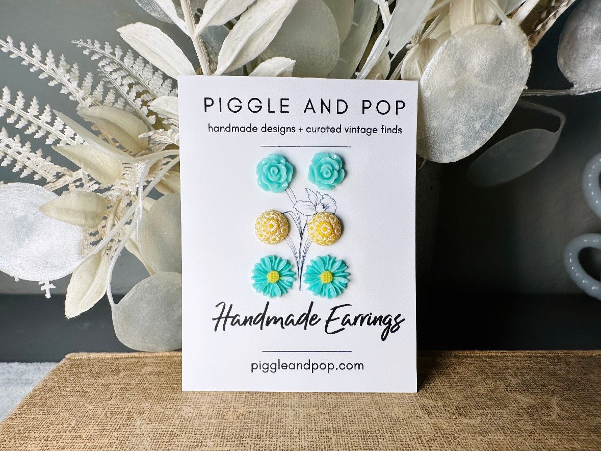 This mint and yellow flower earring set features a summery color combination and unique floral shapes. Cool mint roses, vintage yellow daisy studs with a white floral inlay and turquoise + yellow gerber daisies are paired up in a beautifully colorful set. These handmade resin earrings feature hypoallergenic surgical steel posts (ideal for sensitive ears!). 
