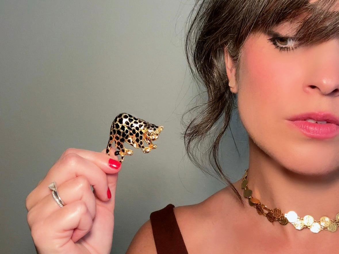 This vintage black and gold spotted leopard brooch is incredible. It is not only a striking statement brooch but easily converts to a pendant with a built in bail- add it to your favorite chain for to transform into a pendant necklace. Signed Park Lane piece in excellent vintage condition, with minimal wear. Incredibly detailed and a wonderful size. Please view all pics and let me know if you have any questions at all.

Dimensions: approximately 2.25". x 1.5"&nbsp;