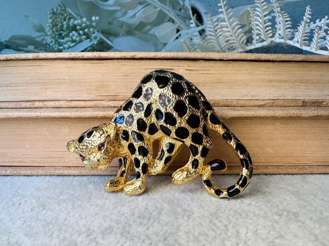 This vintage black and gold spotted leopard brooch is incredible. It is not only a striking statement brooch but easily converts to a pendant with a built in bail- add it to your favorite chain for to transform into a pendant necklace. Signed Park Lane piece in excellent vintage condition, with minimal wear. Incredibly detailed and a wonderful size. Please view all pics and let me know if you have any questions at all.

Dimensions: approximately 2.25". x 1.5"&nbsp;