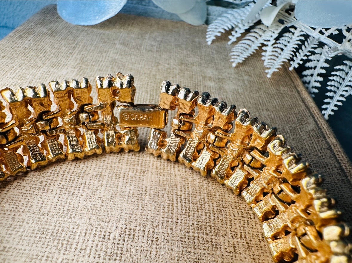 This vintage articulated chunky gold panel bracelet is a showstopper. This signed SC bracelet features articulated gold plated panels with a raised stipple texture throughout. Incredibly well made an in excellent vintage condition. Fastens with a fold over hinge clasp and looks incredible on its own or paired with others for a sensational stack. No flaws to note, please see all pics, from 1973.

Dimensions: 7.75" long, 0.75" wide. Fold over clasp closure.