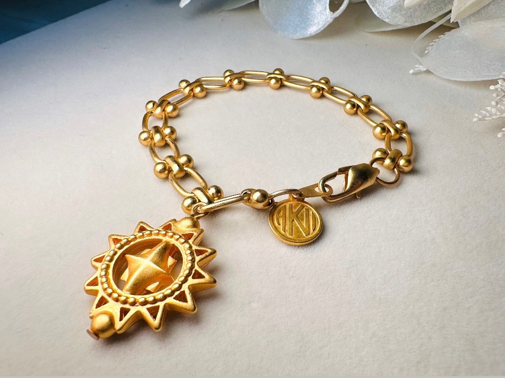 Vintage Anne Klein Bracelet, Matte Gold Link Charm Bracelet with Celestial Sun Pendant and Coin, Etruscan Chunky Gold Chain Bracelet