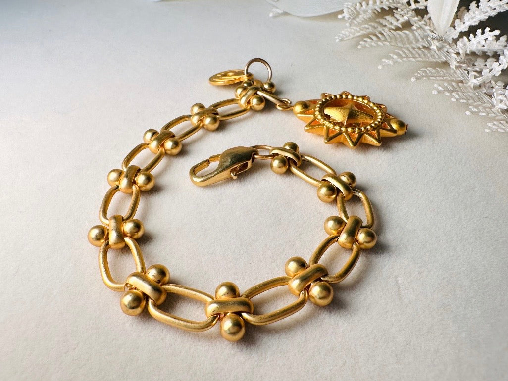 Vintage Anne Klein Bracelet, Matte Gold Link Charm Bracelet with Celestial Sun Pendant and Coin, Etruscan Chunky Gold Chain Bracelet