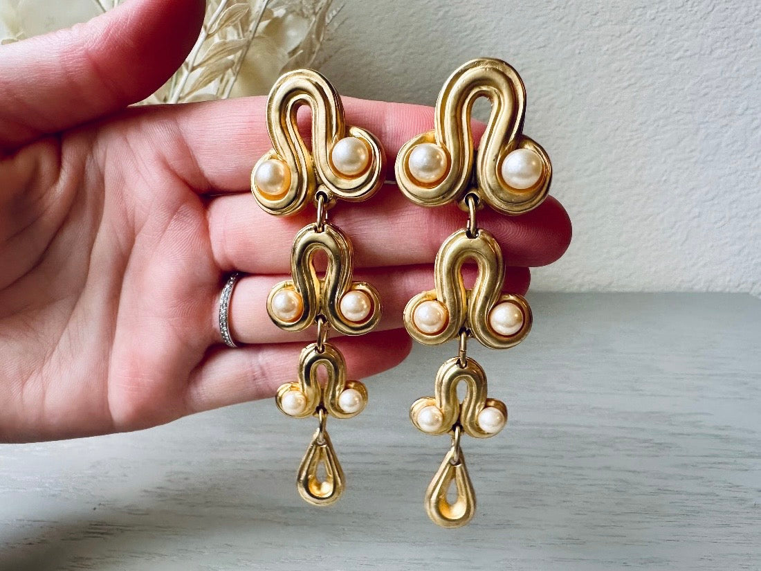 Vintage Blanca Designer Pearl Drop Oversized Matte Gold Clip On Earrings held in hand  from Piggle and Pop 