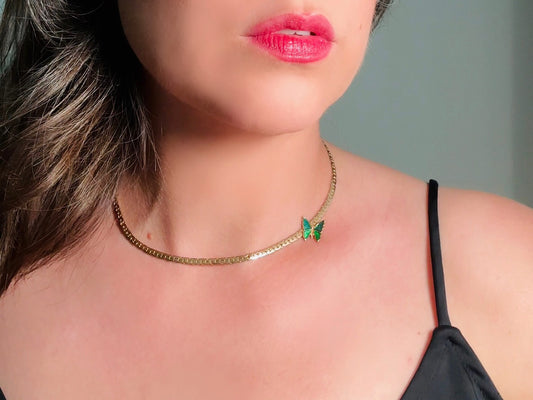 This vintage green and gold shy butterfly necklace is an absolute beauty from the 1970s. Elegantly designed to be worn with the butterfly charm on the right side, this dainty choker necklace is so lovely. The chain is a delicate classic gold herringbone chain, the butterfly is two toned in deep green and teal enamel with a pearlized shimmer. Arrives wrapped beautifully and ready to gift to the butterfly lover in your life. &nbsp;An excellent gift or a thoughtful keepsake for a friend. 