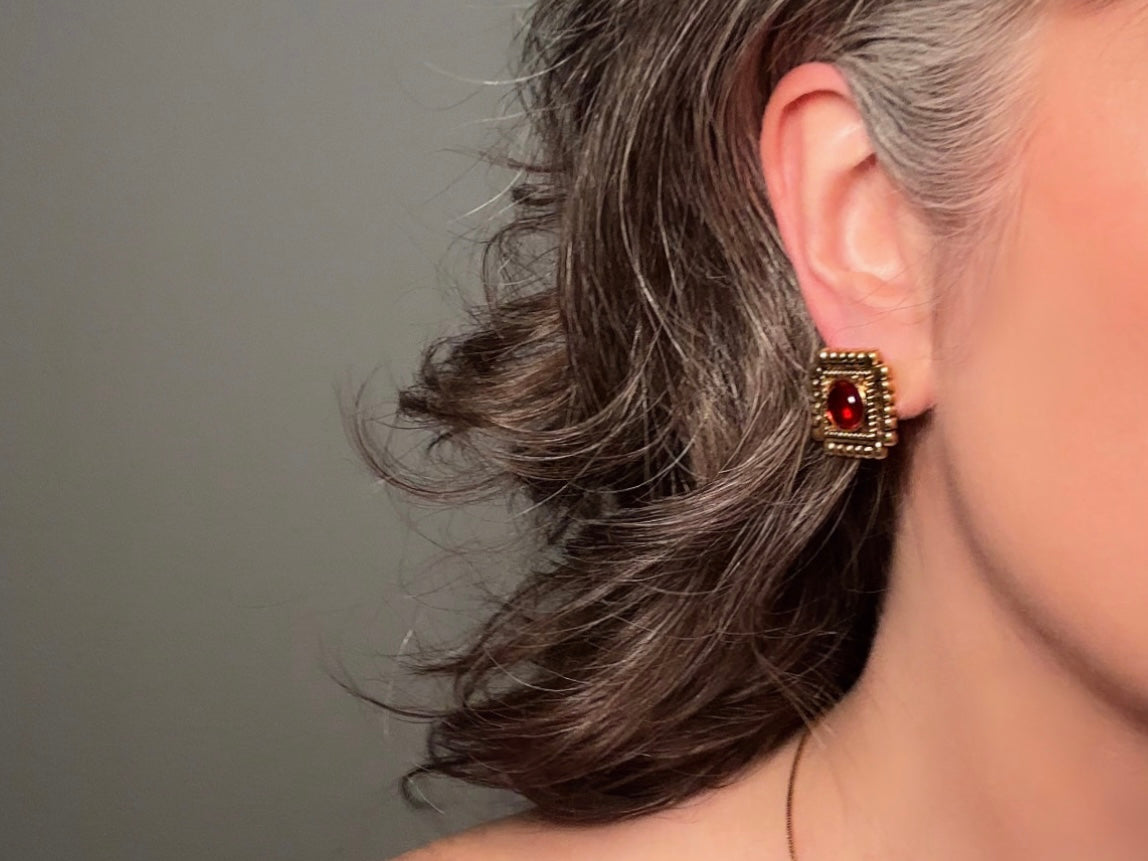 Vintage Etruscan Ruby and Gold 1928 Embossed Square Earrings modelled for size reference