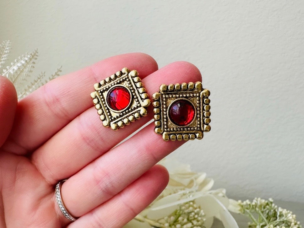 Vintage Etruscan Ruby and Gold 1928 Embossed Square Earrings in hand